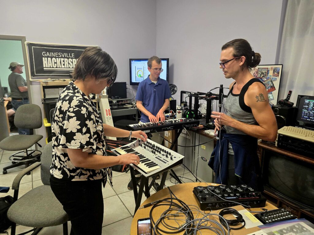 Members performing music using several custom components