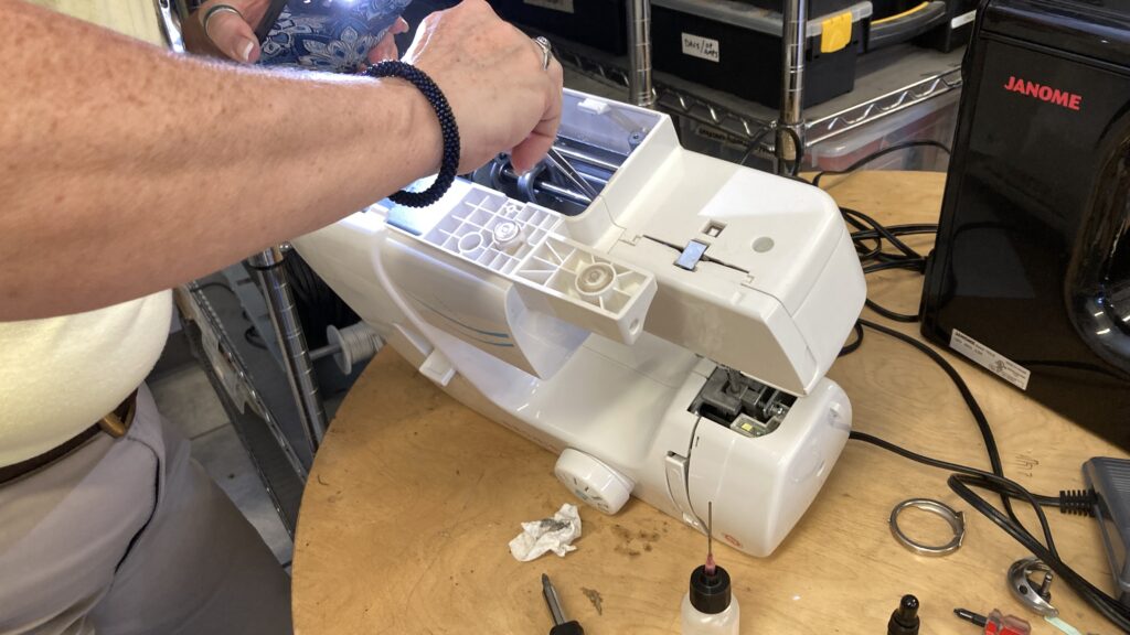 Volunteer Fixing a Sewing Machine